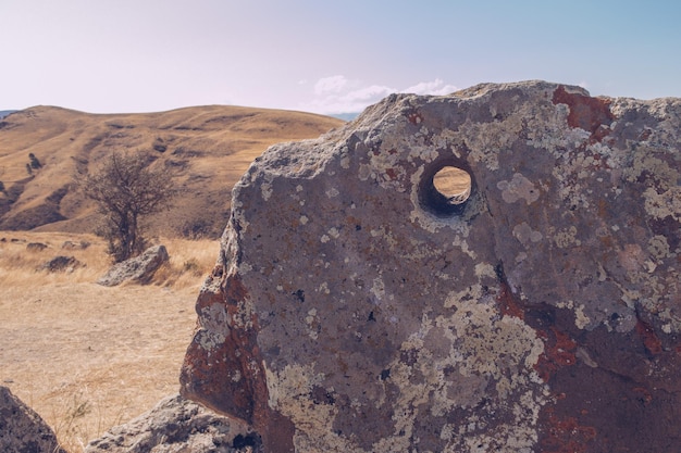 Megalithic standing stones and burial mound of Zorats Karer or Carahunge prehistoric monument in Armenia Armenian Stonehenge stock photography