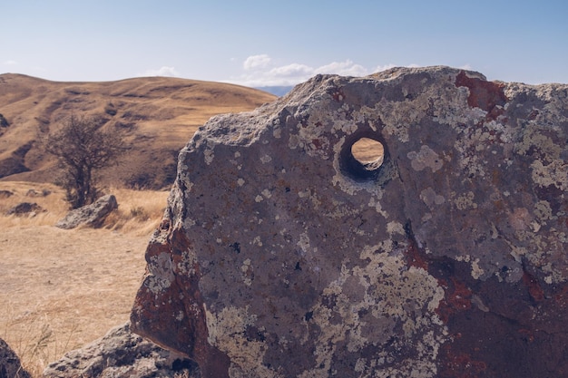 Megalithic standing stones and burial mound of Zorats Karer or Carahunge prehistoric monument in Armenia Armenian Stonehenge stock photography