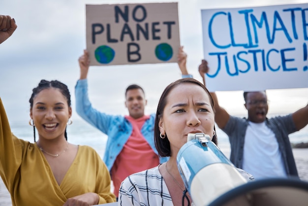 Megaphone climate change protest and Asian woman with crowd at beach protesting for environment and global warming Save the earth group activism and people shouting on bullhorn to stop pollution