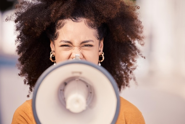 Megaphone speaker and black woman leading a street protest for change equality and democracy Noise politics and unemployment crisis with frustrated female taking action demand government help