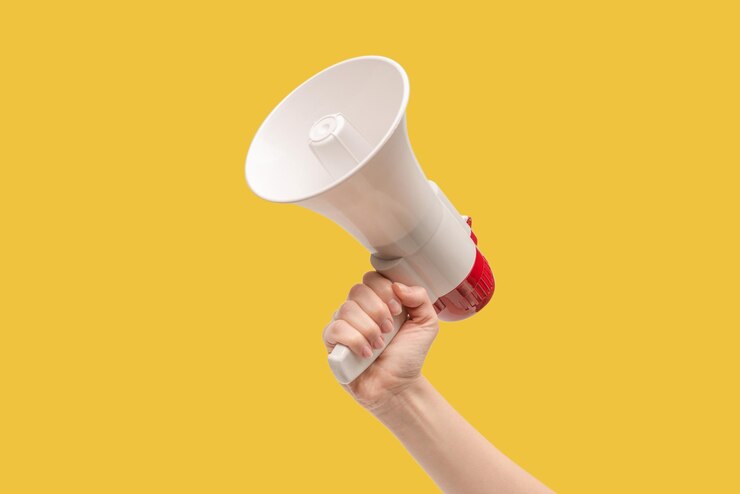 Photo megaphone in woman hands on a white background