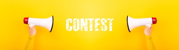 Photo megaphones and inscription contest on yellow background, panoramic image