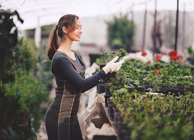 Meisje aan het werk in de tuin met zaailingen in potten