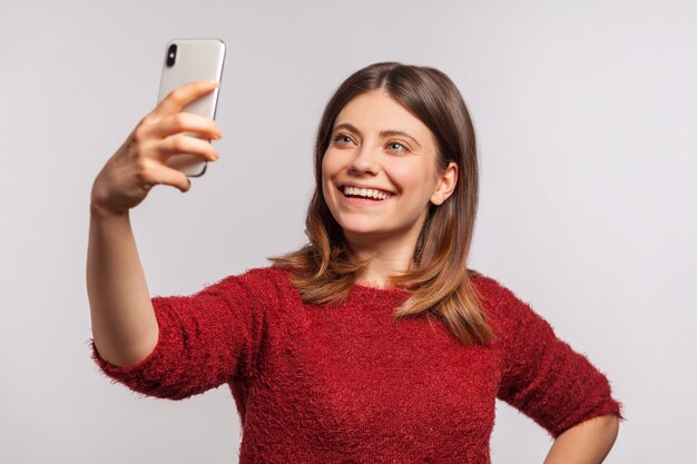 meisje dat mobiel vasthoudt en selfie of videogesprek voert