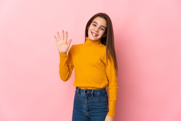 Meisje dat op roze muur wordt geïsoleerd die met hand met gelukkige uitdrukking groet