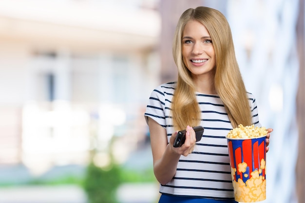 Meisje dat popcorn en het letten op TV eet