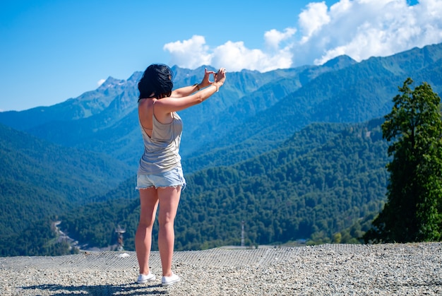 Meisje fotografeert het berglandschap op de smartphone