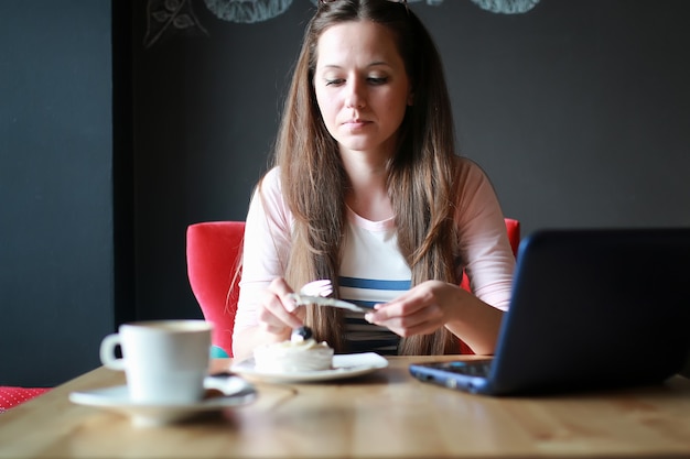 Meisje in een café voor een kopje koffie met het notitieboekje