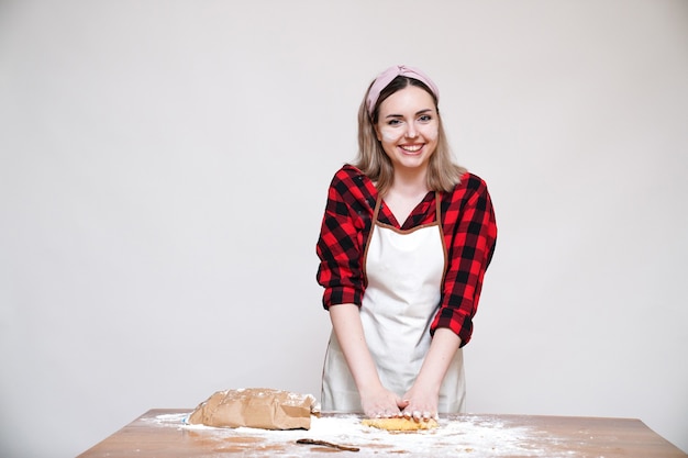 Meisje koken, meisje in schort, meisje grappig gekleurd met bloem, meisje kneeddeeg