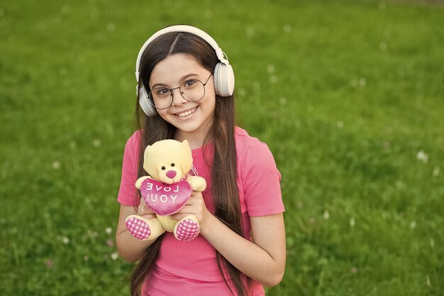 Meisje luisteren zomer melodie draadloze hoofdtelefoon natuur backgroundliving gelukkig leven concept