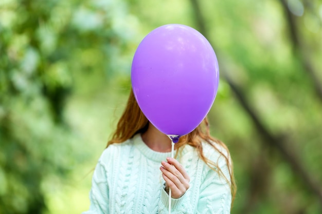 Meisje met ballon in de buurt van gezicht