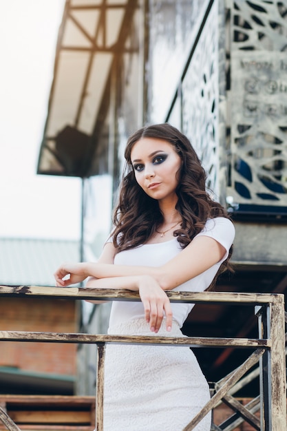 Meisje met lang haar in elegante witte jurk