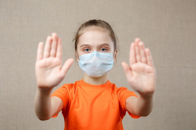 Meisje met masker voor beschermen. resultaat stopbord. stop het virus en epidemische ziekten. coronavirus covid-19. thuisblijven blijf veilig concept. selectieve aandacht.