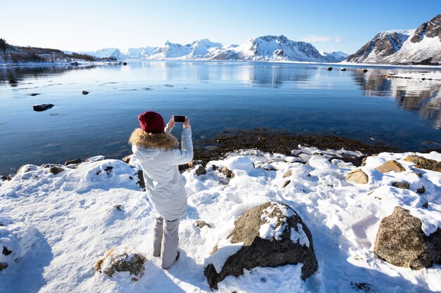 Meisje reist rond de Lofoten-eilanden en maakt foto's met de camera. prachtig Noors landschap. Noorwegen