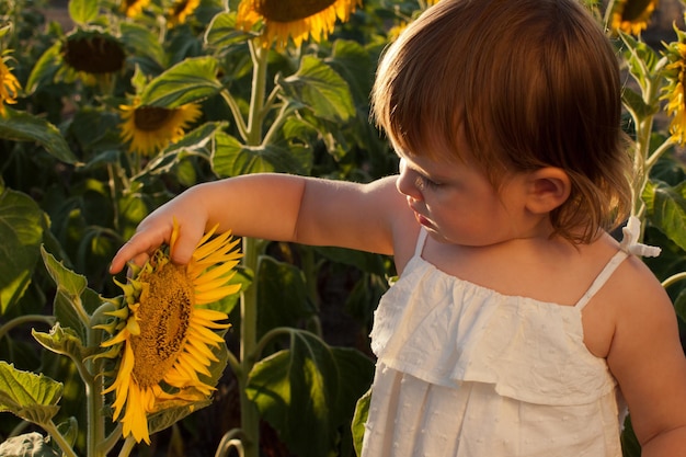 Meisje spelen in zonnebloem veld.