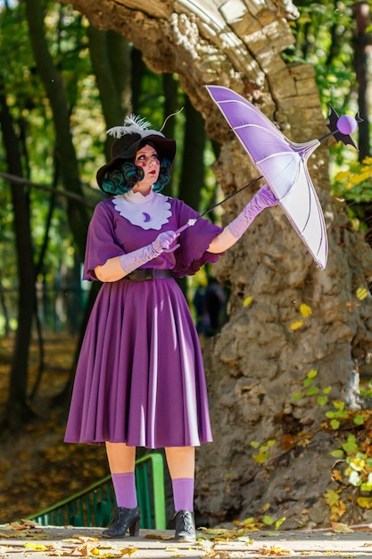 Meisje vrouw koningin vlinder in paarse jurk en paraplu