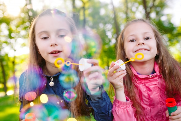 Meisjes spelen met zeepbellen.