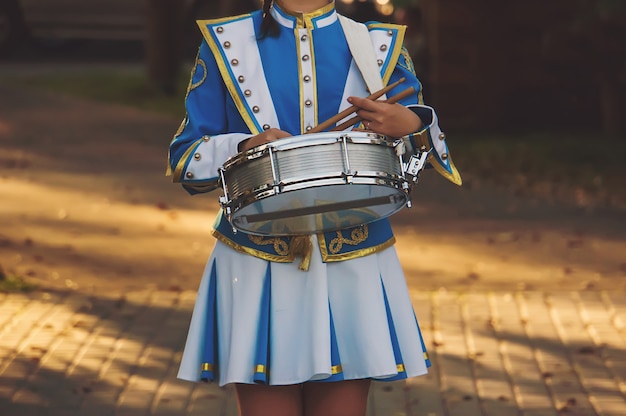 Meisjesdrummer in de prachtige ceremoniële luifel witte ruimen