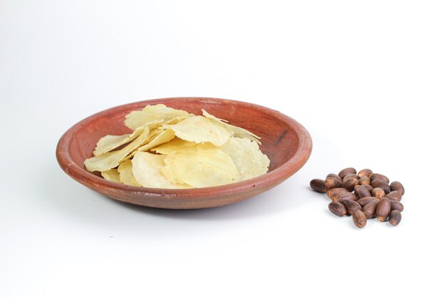 Melinjo Chips on a clay bowl Isolated White