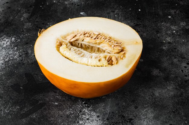 Melon cut set, on black dark stone table background