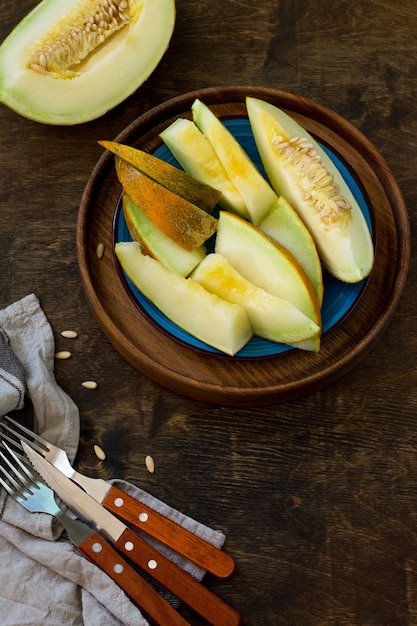 Melon Fresh sliced melon in  a plate on  the wooden table  Copy space