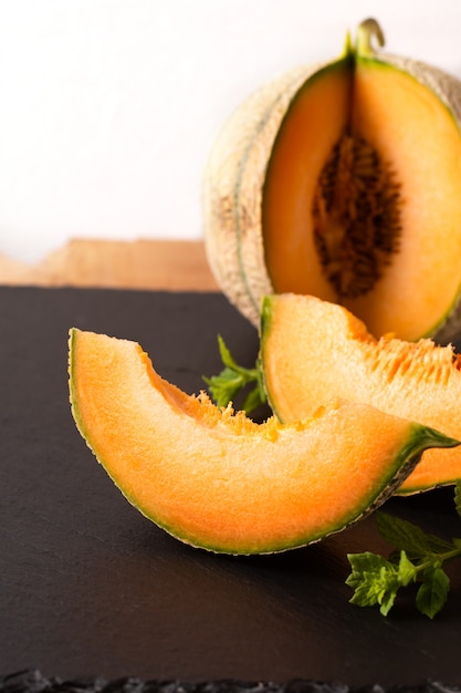 Melon fruit on black slate board