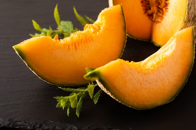 Melon fruit on black slate board