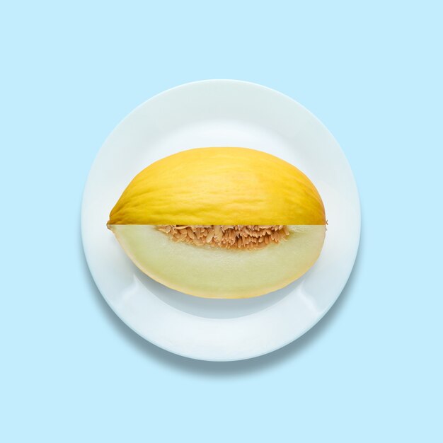 Melon sliced on pastel blue surface.