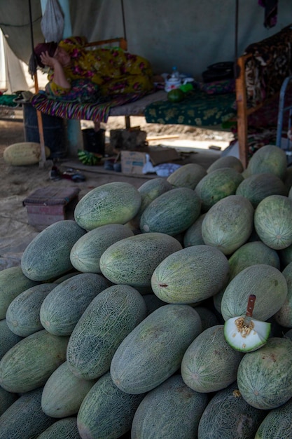 a melon with a knife in market