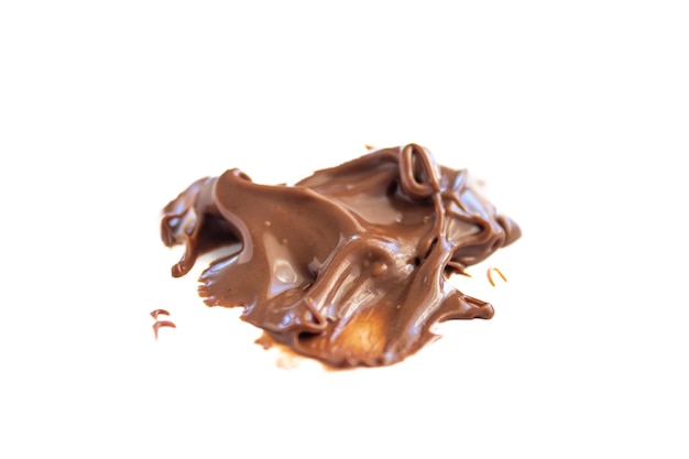 Melted chocolate cream on white background. Top view.