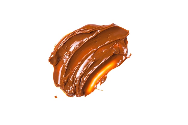 Melted tasty caramel splashes isolated on white background