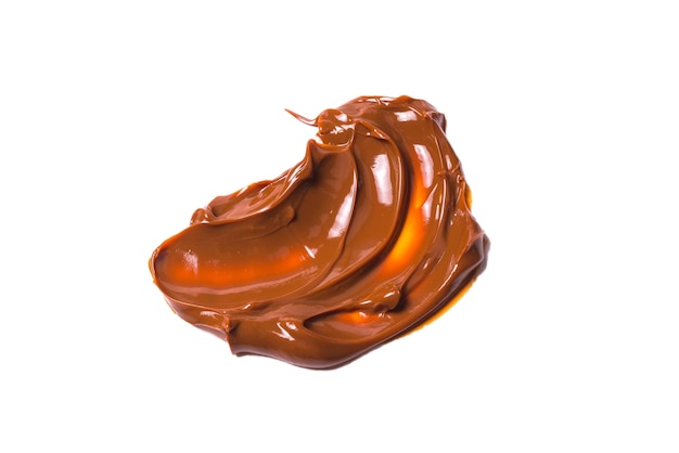 Melted tasty caramel splashes isolated on white background