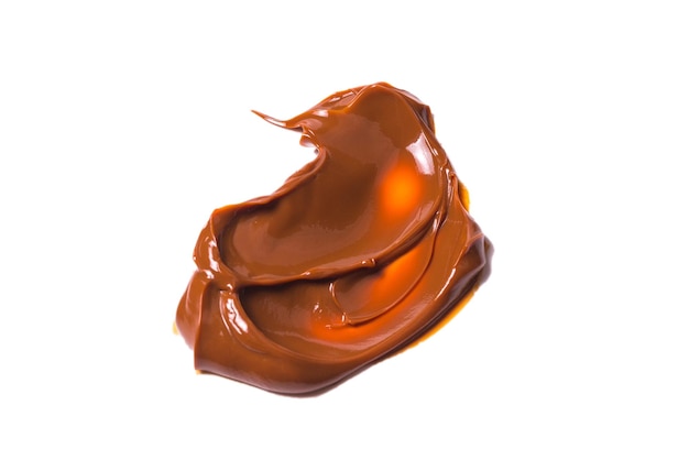 Melted tasty caramel splashes isolated on white background