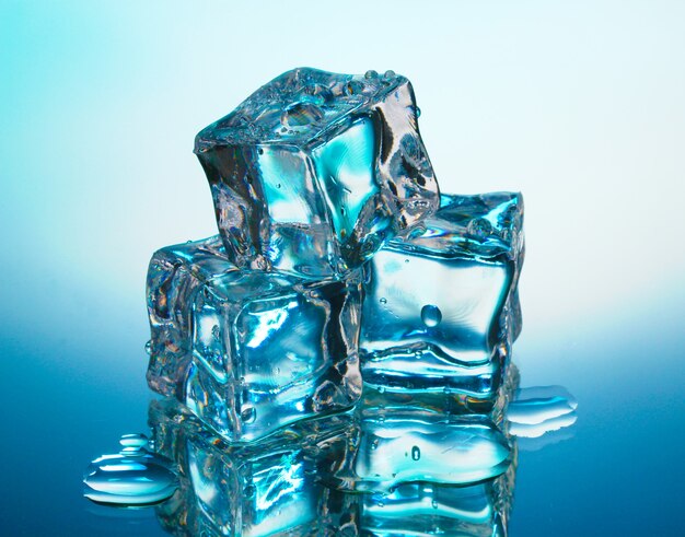 Melting ice cubes on blue background