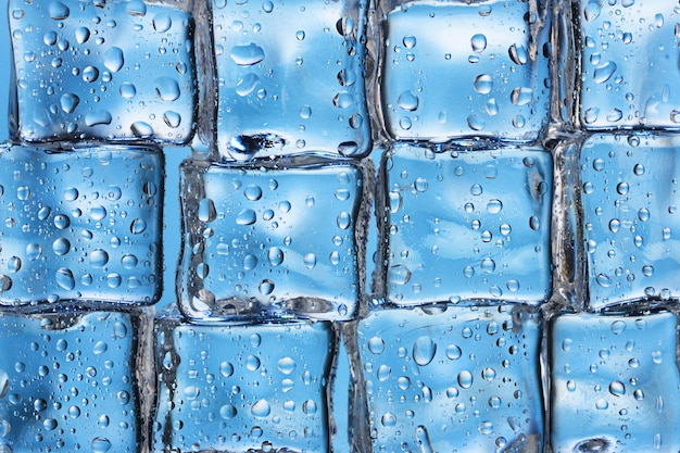 Photo melting ice cubes on blue closeup