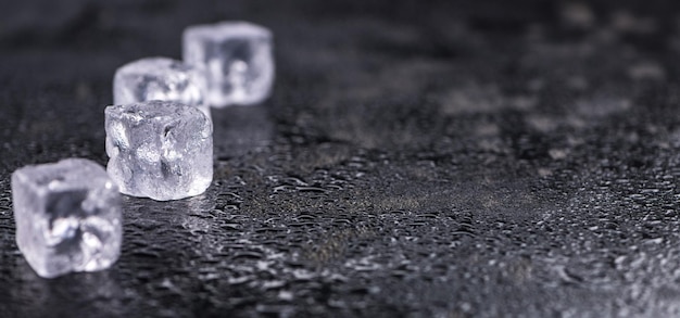 Melting Ice cubes on a vintage slate slab selective focus