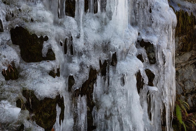 Melting ice on the rock wall during springtime