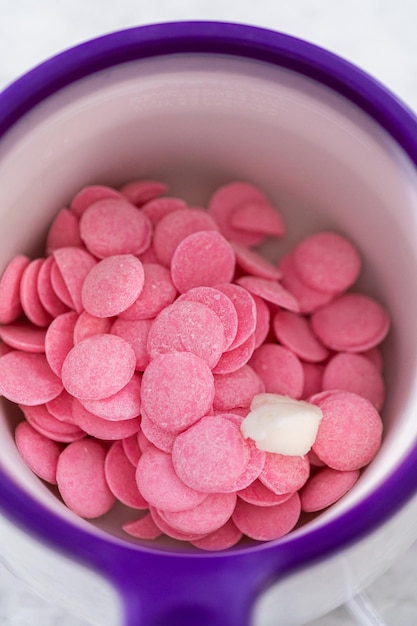 Melting pink chocolate chips in a candy melting pot