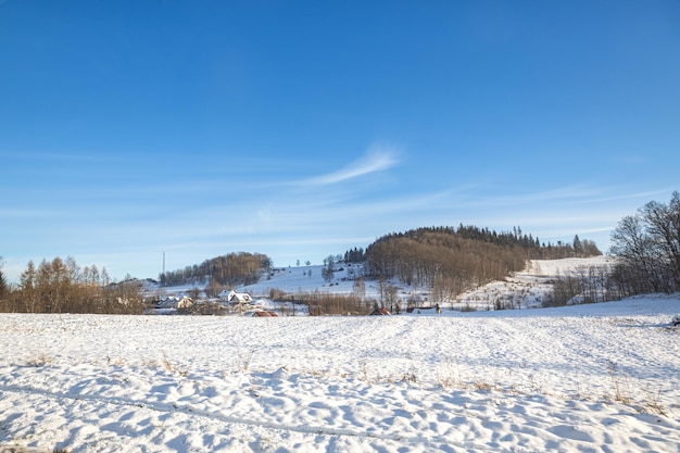 Melting snow on the fields in early spring against the blue sky.