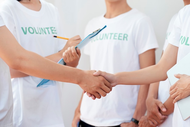 Photo members of volunteering concluding a deal