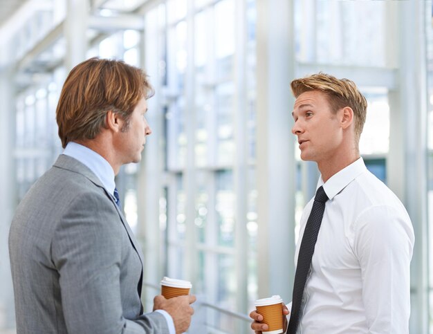 Foto uomini colleghi e discussione d'affari o caffè in ufficio come avvocati di legge per la collaborazione lavoro di squadra o professionale uomini persone caffeina e parlare per il progetto di pianificazione aziendale o networking