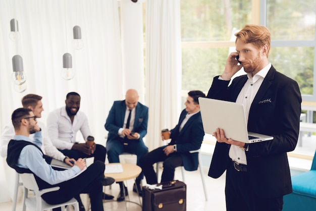 Men in costumes discuss working problems.