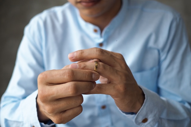 Photo men decided to remove the wedding ring and prepare to divorce documents.