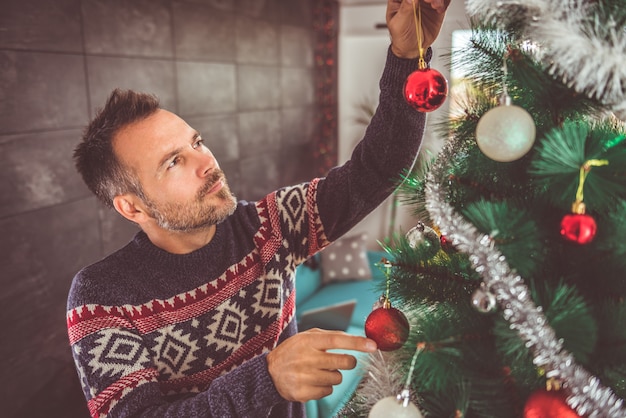 Men decorating Christmas tree