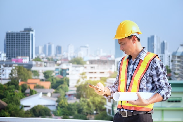 Men engineer stand on tall building