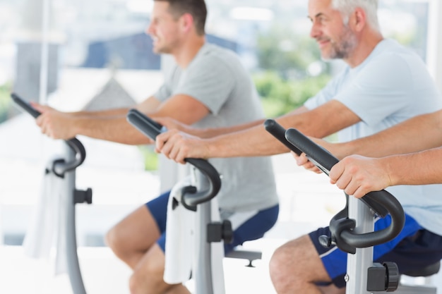 Men exercising on fitness bikes