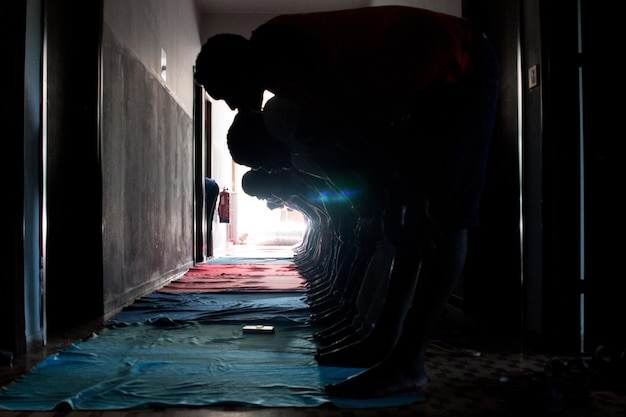 men exercising while standing in corridor