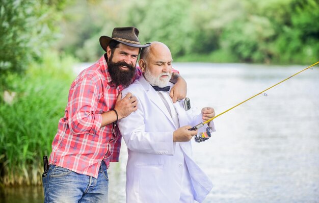 Men friends relaxing nature background personal instructor
bearded man and elegant businessman fish together learn to fish
fish with companion who can offer help in emergency fishing
skills