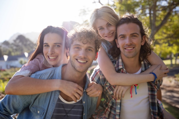 Men giving piggyback rides to women