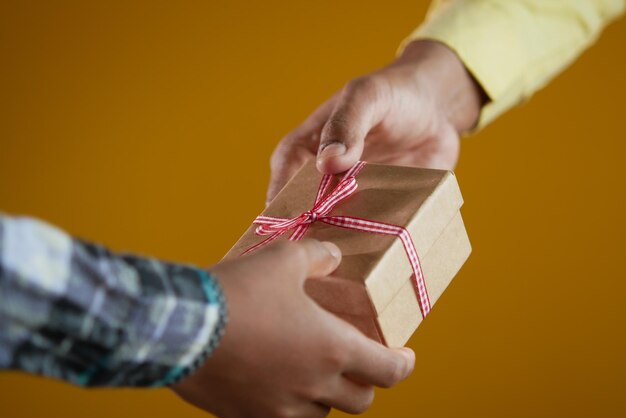 Photo men hand giving homemade gift box